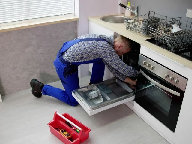 Technician assessing a household appliance